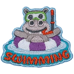 A hippo in a purple and white striped life preserver above the word Swimming.