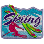 A pink skier is next to two crossed green skis. The word Skiing is across the middle.