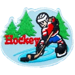 A hockey player skates on pond ice with evergreen trees in the background. The word Hockey is embroidered next to the player.