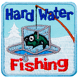 A fish frozen in an iceblock is pulled out of an ice fishing hole. The words Hard Water Fishing are above and below.