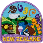 Rolling hills, sheep, flowers, kiwi, wine, and more decorate this New Zealand patch.