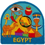 A collection of Egyptian symbols are in front of a pyramid. Such as a camel, pharaoh, bags of spices, and the eye of Ra.