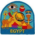 A collection of Egyptian symbols are in front of a pyramid. Such as a camel, pharaoh, bags of spices, and the eye of Ra.