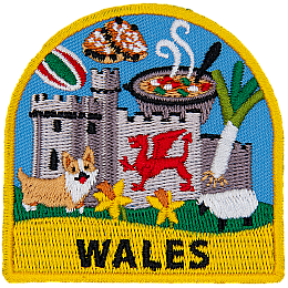 A welsh castle, corgi, sheep and leek are amongst the many symbols of Wales on this patch. The name Wales is at the bottom.