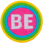 The word Be is encompassed by a pink, blue, green and yellow stripe.