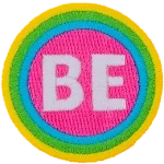 The word Be is encompassed by a pink, blue, green and yellow stripe.