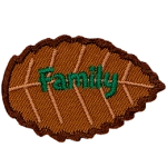 A brown leaf with green text that says family.