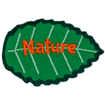 A green leaf with orange text that reads Nature.