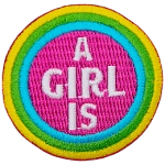 A circular patch with the words A Girl Is in the center. A blue, green and yellow stripe circle around the words.