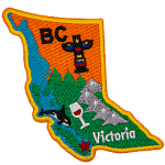 This badge is shaped like the province of British Columbia. It is decorated with BC symbols and its coastline.