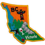 This badge is shaped like the province of British Columbia. It is decorated with BC symbols and its coastline.