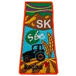 This patch is in the shape of the Canadian province of Saskatchewan with symbols such as the northern lights, grasslands, mountains, prairies, a tractor and a football helmet.