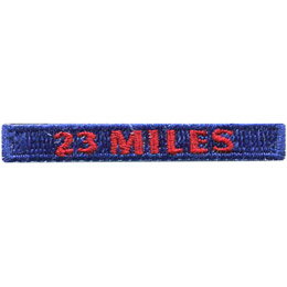 The words 23 Miles are stitched in red on a dark blue rectangle.