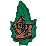 A pair of brown boots on a green leaf.