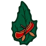 A red canoe with wooden oars on a green leaf.