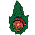 A painted acorn on a green leaf.