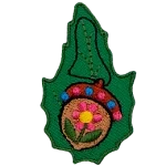 A painted acorn on a green leaf.