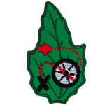 A compass with a red dotted line connected to it and an X on a green leaf.