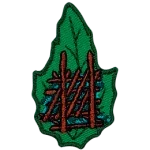 A shelter made from sticks on a green leaf.