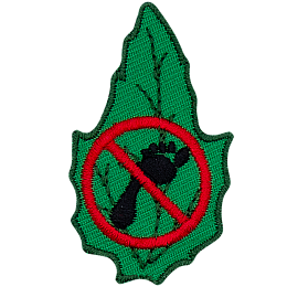 A footprint with a red circle and a line through it crossing it out on a green leaf.