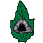 A rocky cave is in the center of a green leaf.