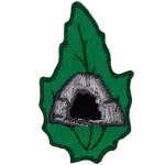 A rocky cave is in the center of a green leaf.