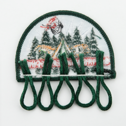 The back of a charm patch with sewn on loops.
