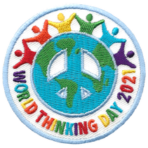 People hold hands around the earth shaped like a peace sign.