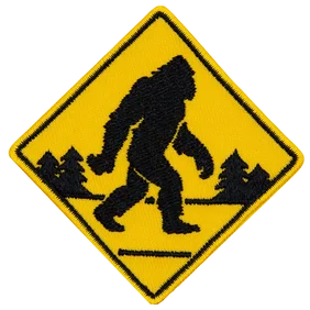 A Sasquatch walking across the road.