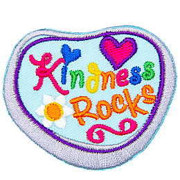 A grey rock has been painted with blue paint and the words Kindness Rocks.