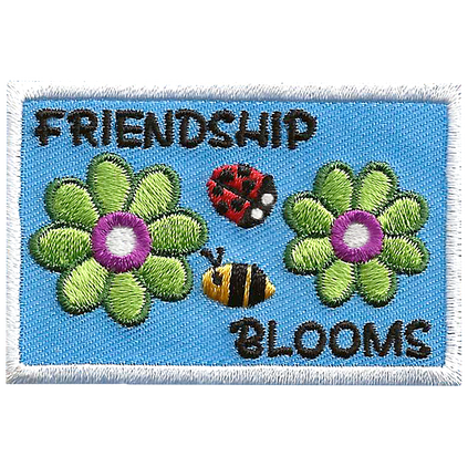 The words Friendship Blooms are surrounding a bee and ladybug, and two green flowers.