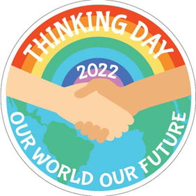 Two people shake hands in front of a globe and rainbow. The text Thinking Day 2022 Our World Our Future is around the circle.