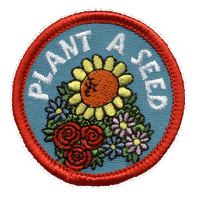 A group of flowers with the words Plant A Seed.