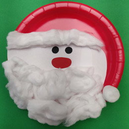 A plate decorated to look like Santa with a long hat.