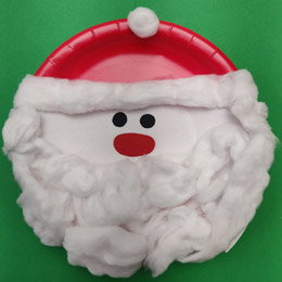 A plate decorated to look like Santa with a short hat.