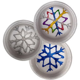 Plates decorated to look like snowflakes.